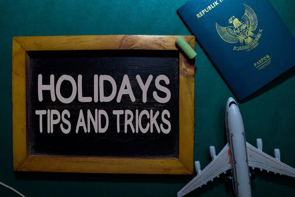 Holidays Tips and Tricks write on a black board isolated on Office Desk
