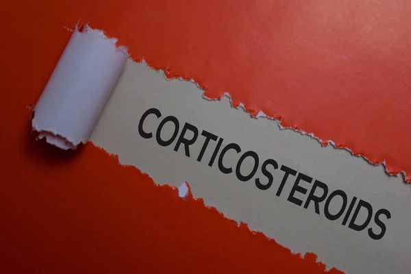 Corticosteroids Text written in torn paper. Medical concept