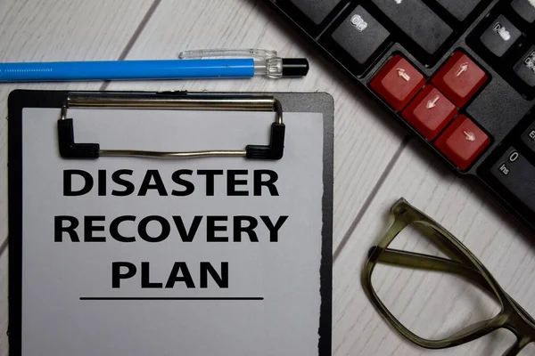 Disaster Recovery Plan write on a paperwork isolated on office desk.