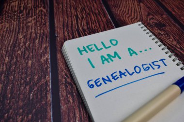 Hello I am A Genealogist write on a book Isolated on wooden table background clipart