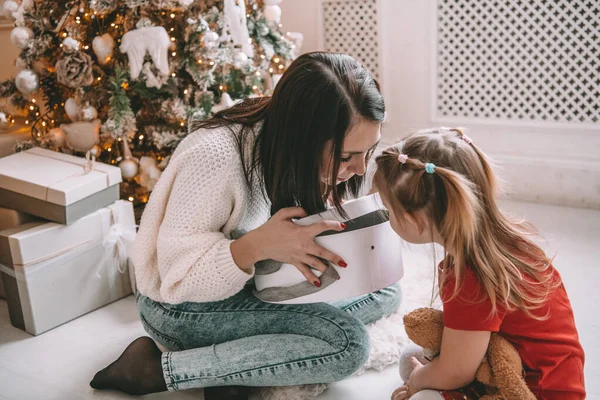 Sorpresa regalo de Navidad - niña y mujer delante del árbol decorado — Foto de Stock