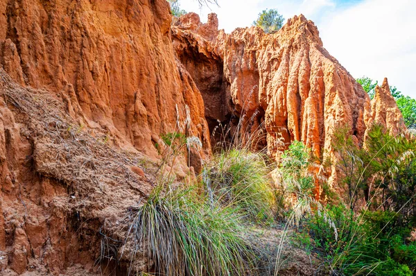 Grandes rocas de arcilla roja y acantilados bañados por las lluvias de invierno y los flujos de agua superficial. Cantera de arcilla, minas paisaje en el Parque Nacional en Campania, Italia —  Fotos de Stock