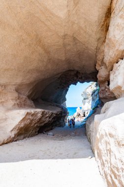 Ünlü Rotonda sahilindeki eşsiz deniz mağarasından inanılmaz deniz manzarası. Küçük plajda dinlenen turistler mağarada yürürler. Tyrhenian deniz manzarası.