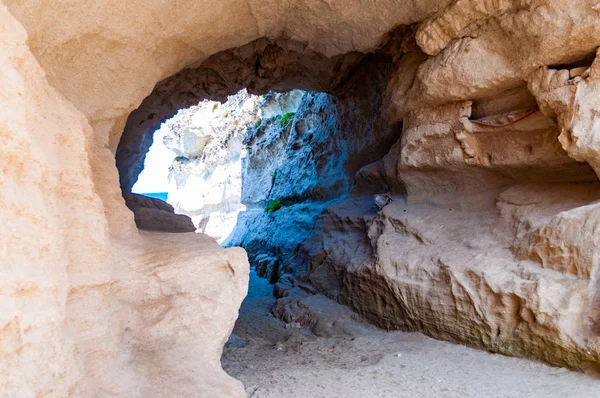Vista lateral en el túnel de entrada redonda a la cueva marina única en roca masiva en la ciudad de Tropea cerca de la famosa playa de Rotonda. Orilla del mar Tirreno en el sur de Italia —  Fotos de Stock