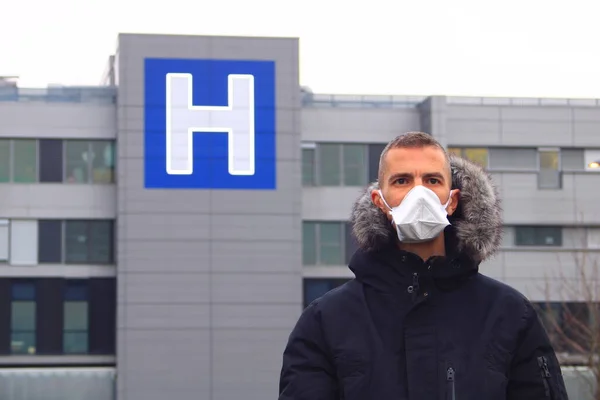 Person wearing a surgical mask. Protection on the face for the airways, against corona virus or flu. Prevents particles from pollution. Symbol of a hospital bokeh.