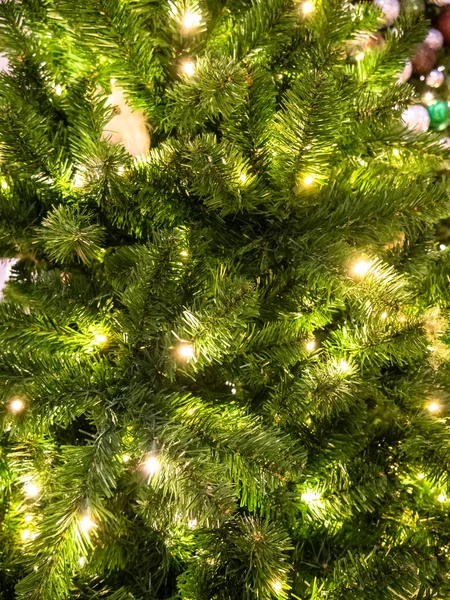 Grön Christmass träd gran struktur med ljus och bollar bakgrund. — Stockfoto