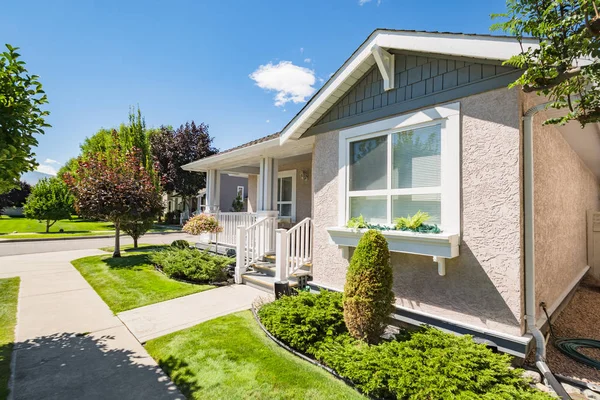 Entrance of residential house with concrete pathway in front of the house