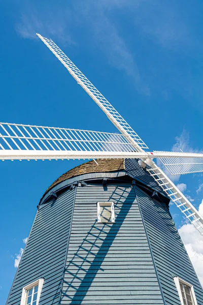 Vintage wind mill decorated with lights on blue sky background. — Stock Photo, Image