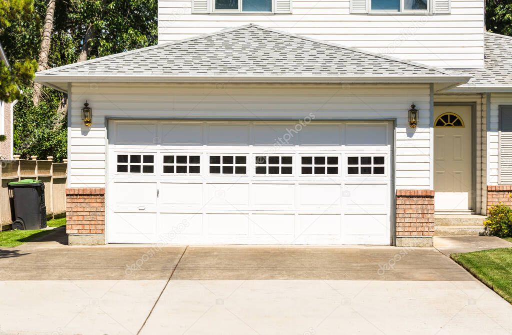 A perfect neighbourhood family house with wide garage door and concrete driveway