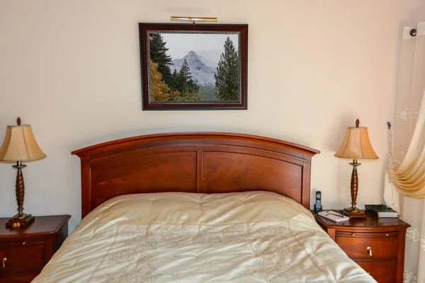 Hermoso dormitorio con luces de mesa en mesitas de noche al lado de la cama . —  Fotos de Stock