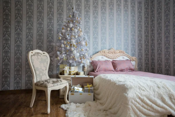 Christmas scene with a bed, Christmas tree, gifts and a chair