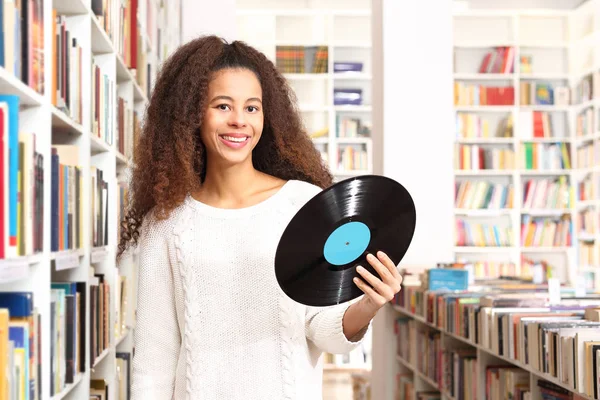 Vinyl, girl holding a black disc. — Stock Photo, Image