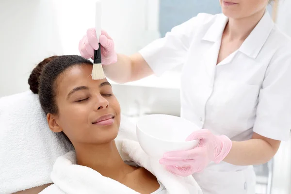 Kosmetolog. Ansiktsmask appliceras kosmetiska borste — Stockfoto