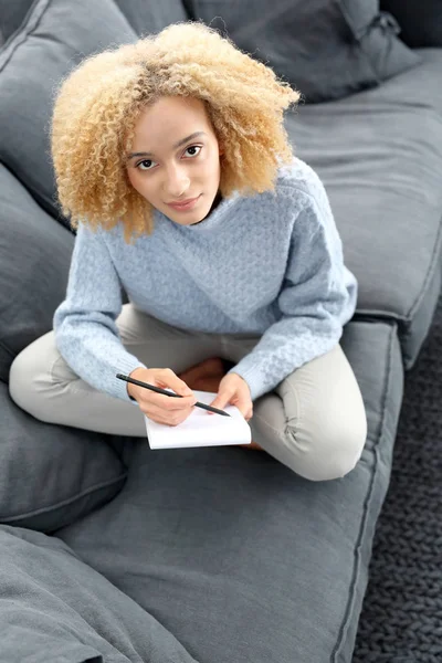 Household bills.The girl writes in notebook — Stock Photo, Image