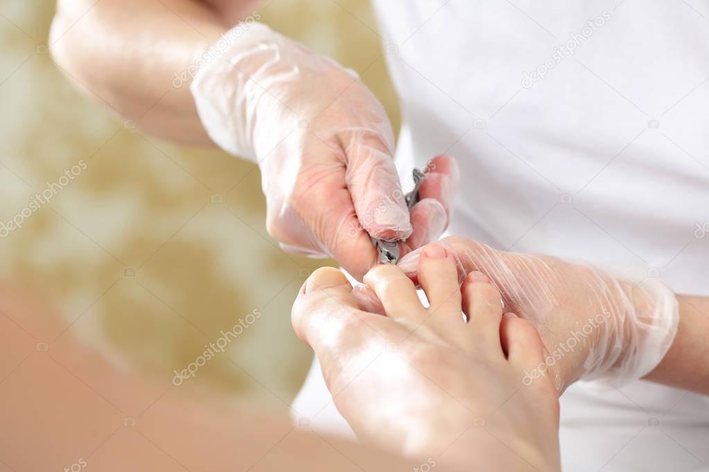 Nail clipping at the feet, woman on pedicure.
