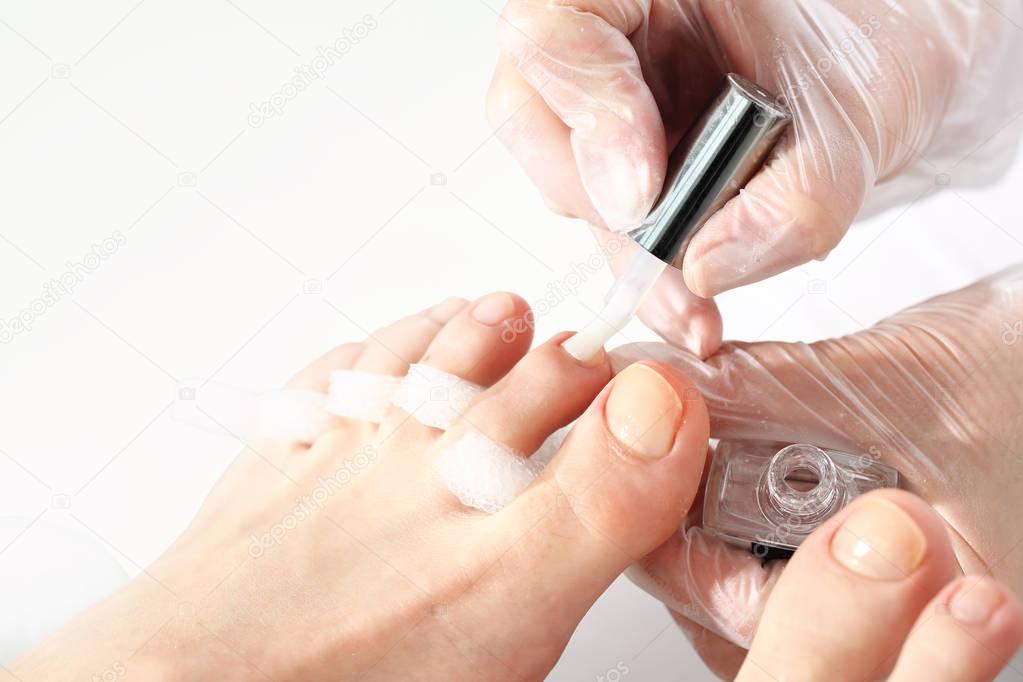 Pedicure, nail painting at the feet