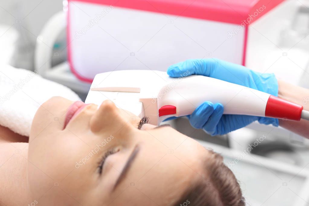 Laser hair removal from the face. Woman in the clinic of aesthetic medicine.