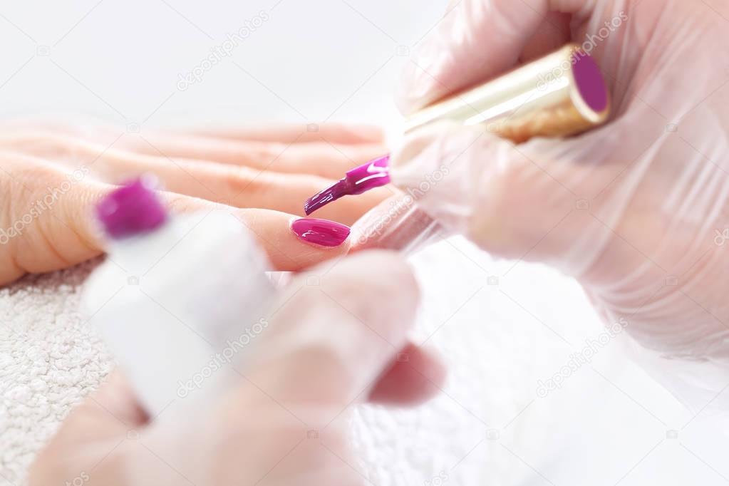 Nail painting on pink color