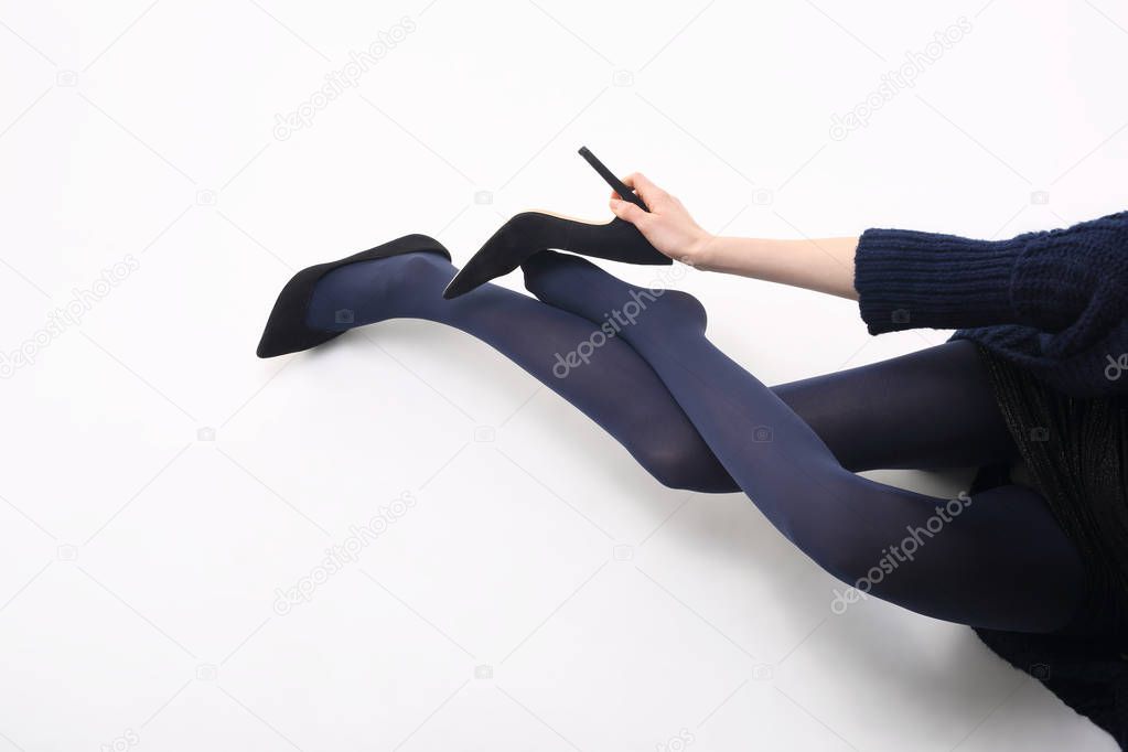 Tights. Beautiful and shapely legs of a woman in opaque tights.