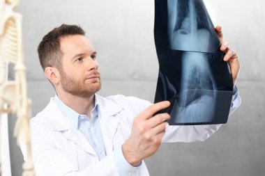 Medical specialist. The doctor is watching an X-ray. clipart