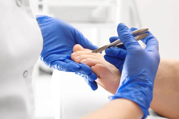 Pedicure, cutting skins.The beautician cuts the skin with fingernails and performs professional pedicure. — Stock Image Pedicure Cutting Skins Beautician Cuts Skin Fingernails Performs Professional Pedicure Royalty Free Stock Photos