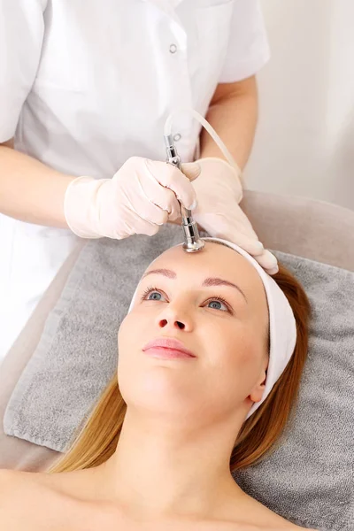 Acne treatment, oxygen infusion in cosmetics. A woman in a beauty salon during a care treatment using active oxygen