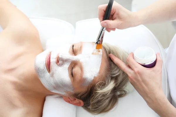 Cosmetic Mask Beautician Puts Silver Mask Woman Face — Stock Photo, Image