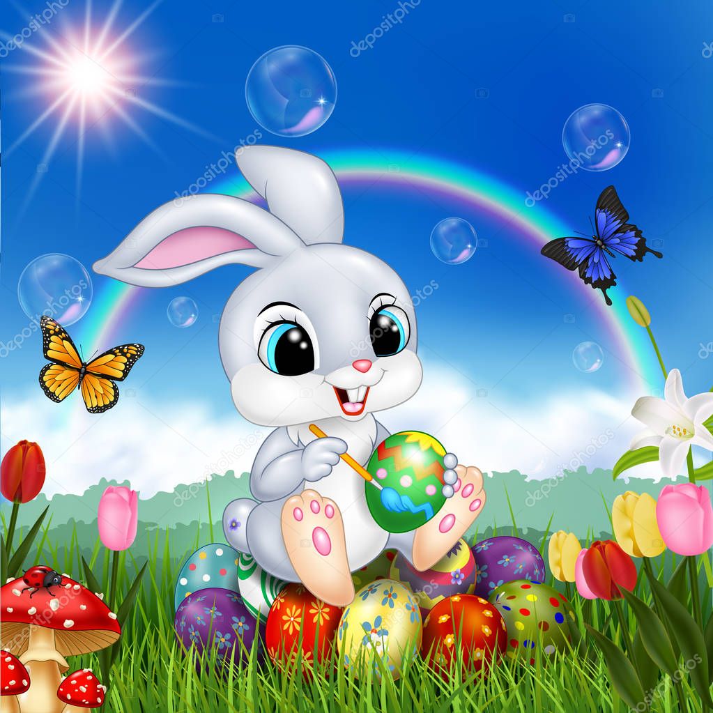 Cartoon rabbit decorating an Easter egg