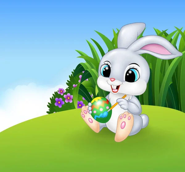 Lindo Conejo Pascua Pintando Huevo Fondo Pradera — Vector de stock