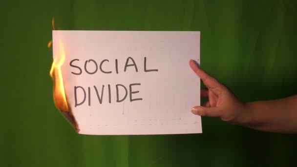 Hand Holds Burning Paper Social Divide Text Word Green Screen — Stock Video