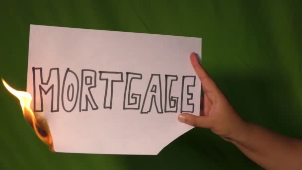 Hand Holds Burning Paper Mortgage Text Word Green Screen — Stock Video
