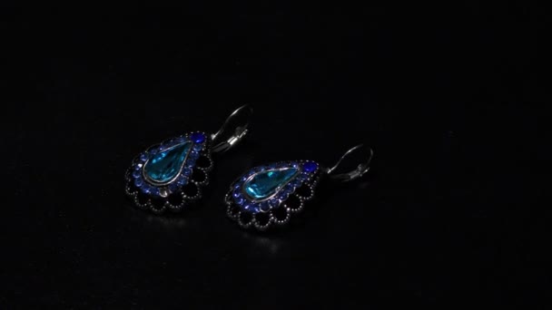 Two Blue Earrings Display Dark — Stock Video