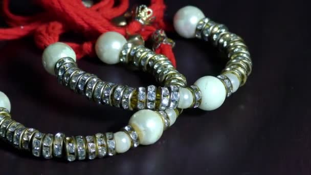 Two Red Threaded Wrist Bracelets Jewellery White Pearls — Stock Video