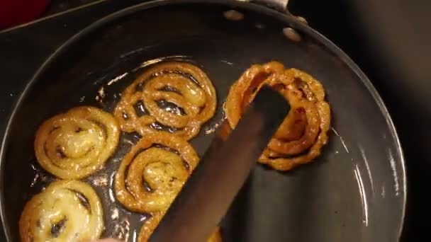 Frying Collecting Brown Jalebi Pieces Heated Oil Pan Hands — Stock Video