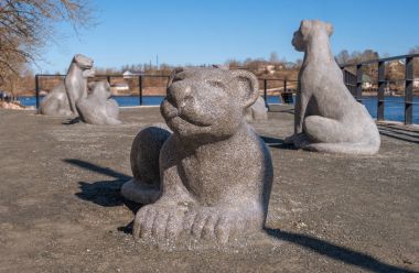 Narva, Estonia - March 16, 2017: Sculptural group -Lions- on the promenade along the Narva River. Sculpture symbolizes semicity, tradition and care for children. clipart