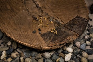 Primitive gold panning equipment with gold nuggets clipart