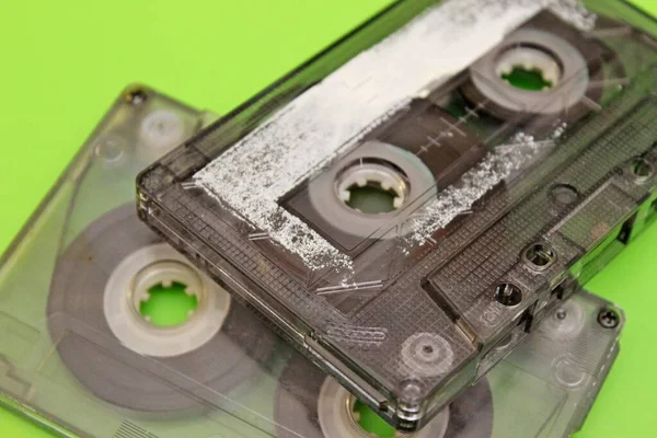 Old audio cassettes arranged on a green background — Stock Photo, Image