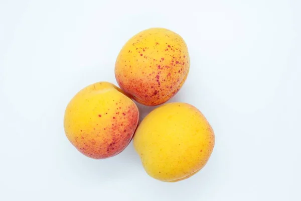 Delicious beautiful apricots located on a white background — ストック写真