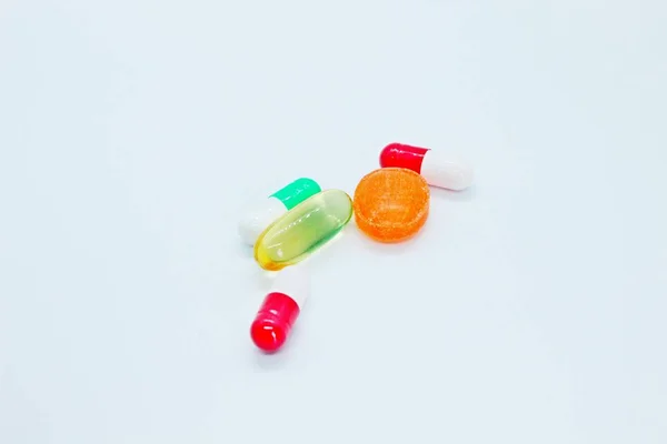 Flerfärgade piller finns på en vit bakgrund — Stockfoto