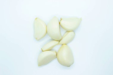 Peeled garlic located on a white background