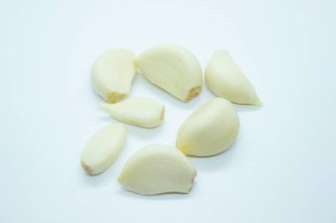Peeled garlic located on a white background