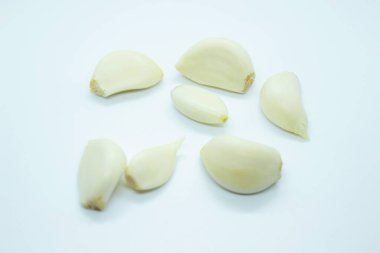 Peeled garlic located on a white background