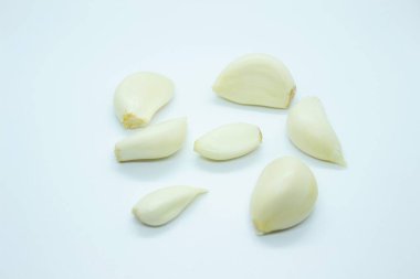 Peeled garlic located on a white background