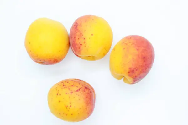 Tasty ripe beautiful apricots located on a white background — ストック写真