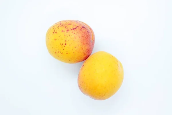 Tasty ripe beautiful apricots located on a white background — ストック写真