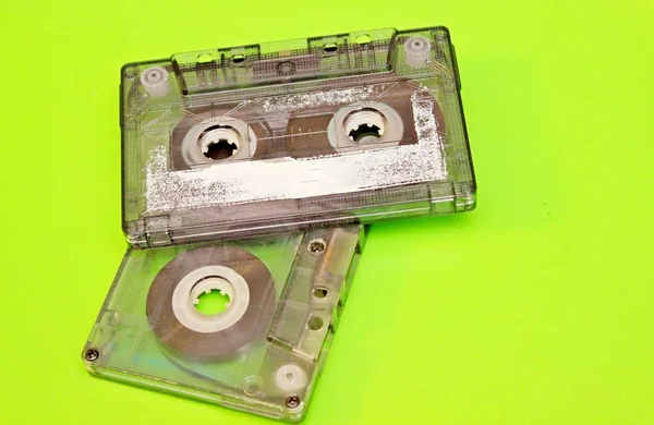 Old audio cassettes located on a green background — Stock Photo, Image