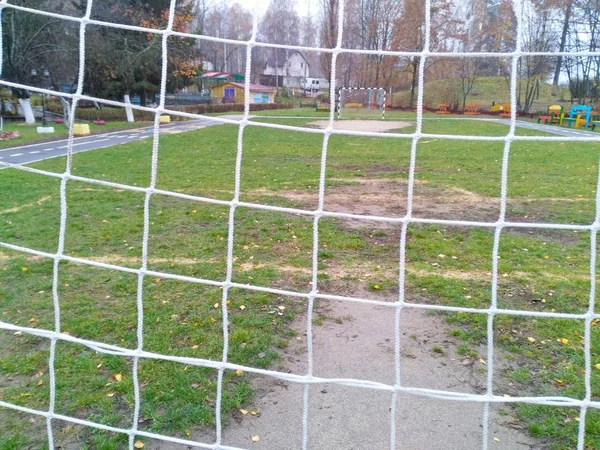 White soccer net on the goal of a soccer field