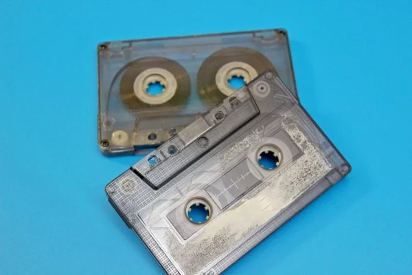 Old audio cassettes are located on a blue background