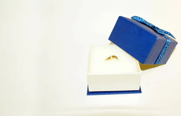 Gift, golden ring with diamonds in a gift box.