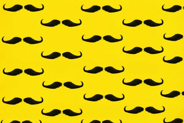 Black male mustache on a yellow background, illustration.